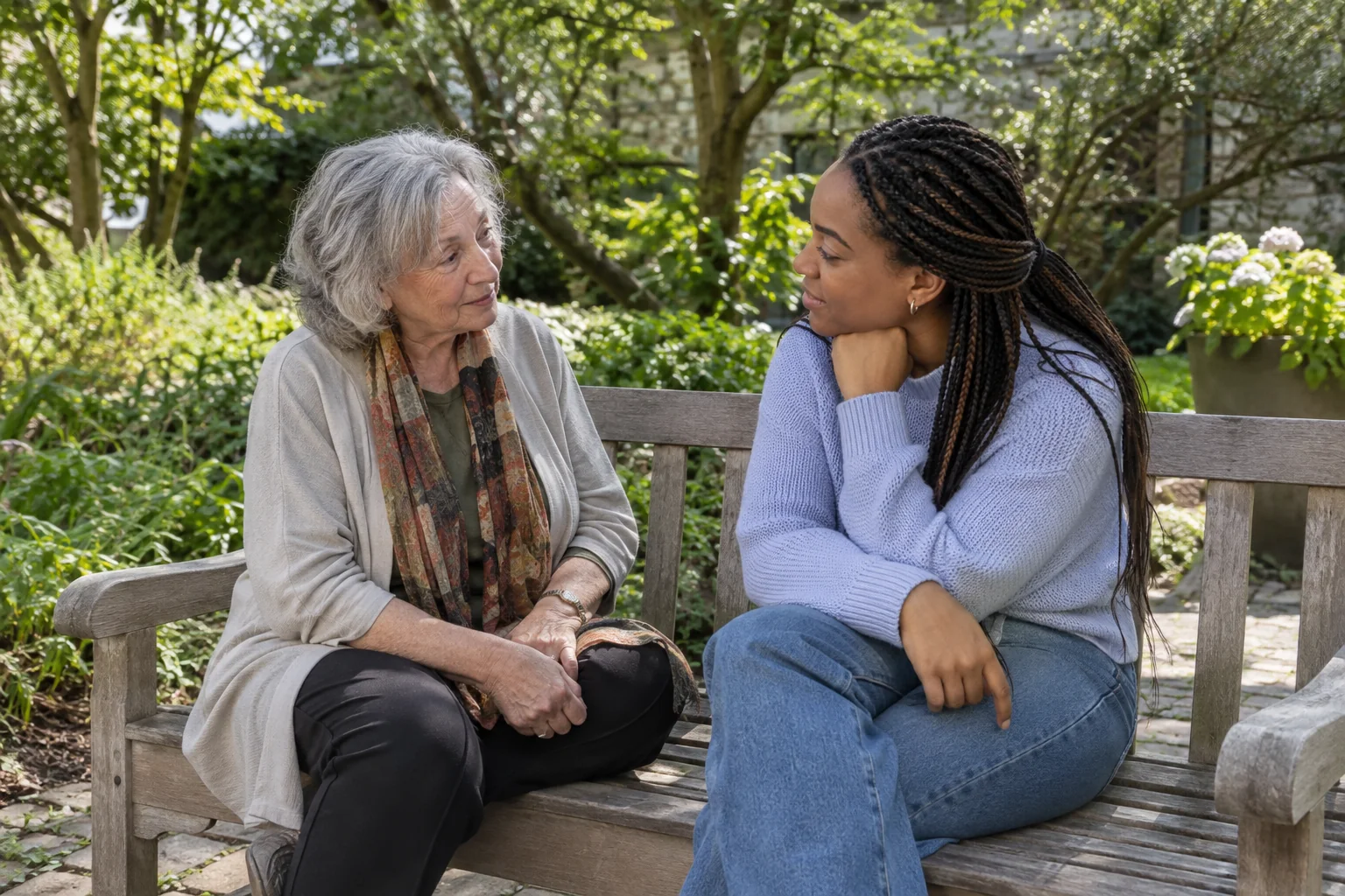 Two adults sharing a quiet, supportive conversation in a courtyard